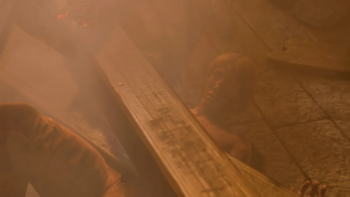 A man trapped under a beam in a burning building in BG3.